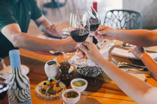 Constanza Miranda Wine Friends La Piu Belle VIK Glass Food Pepper Plates Man Woman Fork Hands Friends Napkin red tasting toast cutlery