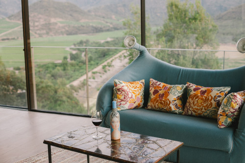 VIK Hotel Constanza Miranda  La Piu Belle Product Bottle artistic shots landscape window view sofa lamps glass wine valley mountains 
cushions