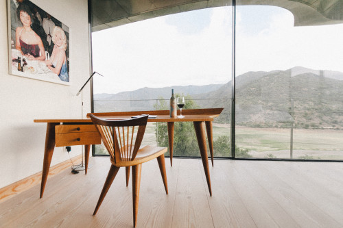 VIK Hotel Constanza Miranda desk chair wood product bottle artistic shots wine glass window view painting mountains landscape lamp