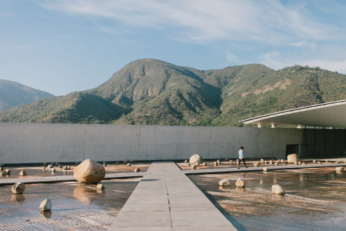 Exterior Constanza Miranda  water rocks footpath path  mountains landscape woman hat walking clouds sky Sloping Plaza architecture