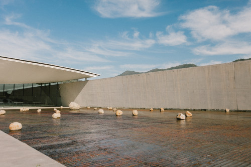 Exterior Constanza Miranda  water rocks footpath path mountains 
clouds sky Sloping Plaza architecture
