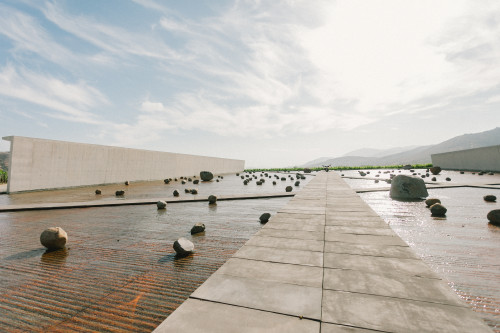 Exterior Constanza Miranda  water  rocks  footpath path mountains crops landscape clouds sky Sloping Plaza architecture