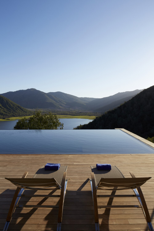 VIK swimming pool landscape nature mountains view lounging chair towels sky reservoir lake  Chile indulgence