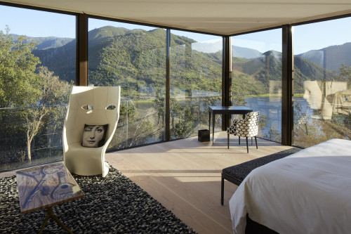 Interior VIK Hotel Rooms Fornasetti Suite double window view landscape reservoir carpet bedroom double bed chair table desk mountains nature instruments cushion trees green Guest Chile lake