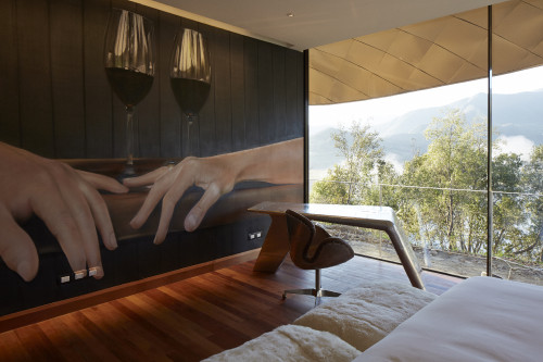 Grafitti Suite painting window view bed hands glass red wine chair desk mountains trees Interior VIK Hotel Rooms Guest Chile