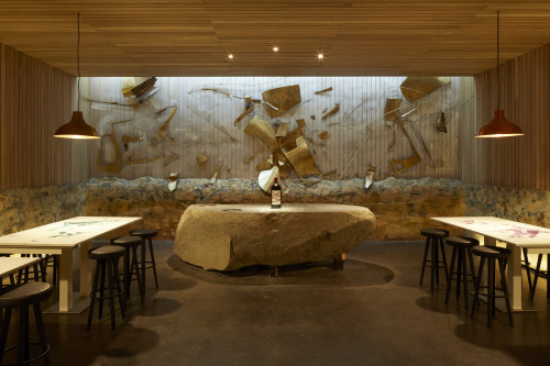 interior tasting rooms  wood VIK sculpture bottle artistic shots stone tables lamps map harvest