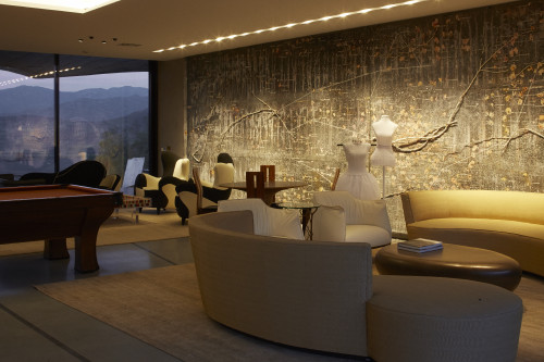 interior VIK hotel Living room mannequin sofas table pool mountains window view books lamps billiard sculpture chairs