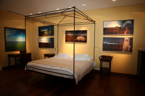 Turell Suite Estancia VIK Jose Ignacio Uruguay double bed room paintings chair table light desk pillows cushions