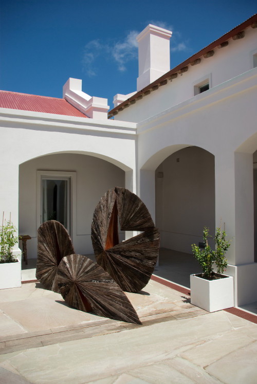 Estancia VIK Jose Ignacio Uruguay  Pascal Statue West Patio sculpture chimney blue sky plants pots