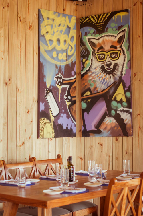 La Susana Restaurant José Ignacio Uruguay artwork setting table chair dining room interior glass oil vinegar napkin fork knife butter plate wood cutlery  interior