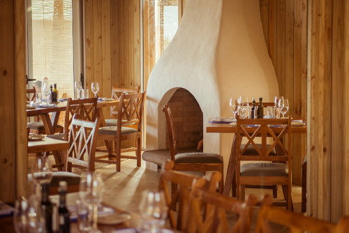 La Susana Restaurant José Ignacio Uruguay  fireplace dining room chair table setting glass oil vinegar napkin interior