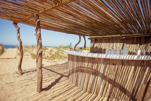 La Susana Restaurant José Ignacio Uruguay Bar sand sea beach blue sky water wood glass fruits bottle exterior