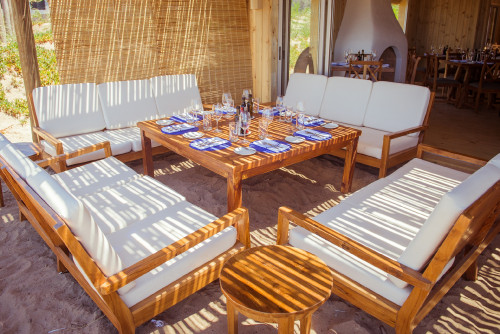 La Susana Restaurant José Ignacio Uruguay setting table sofa sand glass fork knife napkin fireplace lounge dining exterior interior