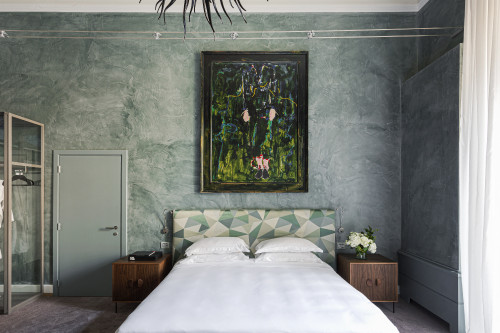 Galleria VIK Milano Italy Palace Rooms Suites 208 Mario Schifano night table bedroom 
double bed door 
headboard lamps books pillows closet paintings flowers