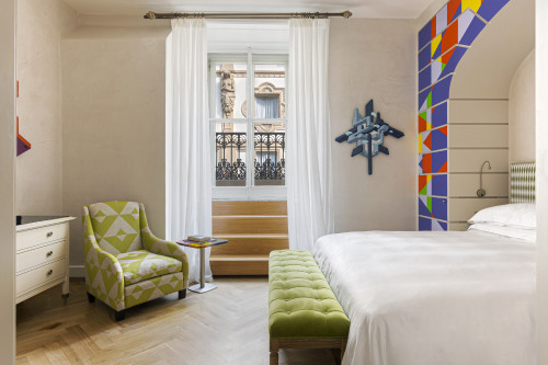 Galleria VIK Milano Italy Suites Deluxe Gallery Rooms 320 Rendo 
bedroom double bed window view headboard lamps pillows curtains sculpture armchair furniture Chest of drawers stairs steps books Vittorio Emanuele II balcony table bench