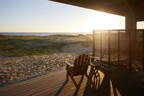 Bahía VIK José Ignacio Uruguay Piedra Librillo Bungalow terrace sunset sand chair table sea wood exterior