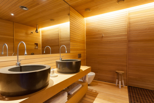 Bahía VIK José Ignacio Main Building Suites Lopez Laje bathroom sink stool towels mirror wood shower lights