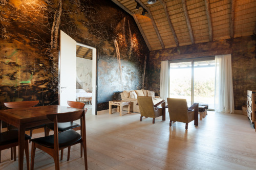 Bahía VIK José Ignacio Quincha Ramas Bungalow living room sofa window view wood curtains furniture  cushions interior armchair Chest of drawers stool dining chair table door bedroom basket ceiling