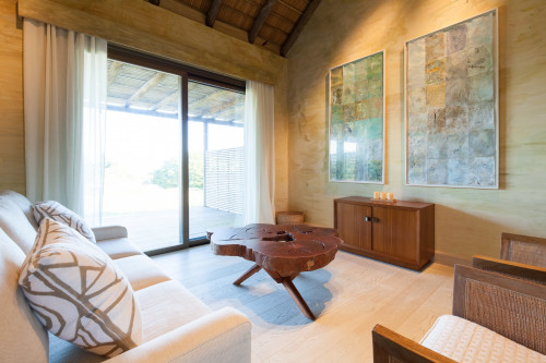 Bahía VIK José Ignacio Quincha Cardozo Bungalow living room sofa window view wood curtains furniture paintings  cushions candles basket
bush interior armchair