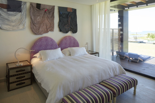 Bahía VIK José Ignacio Isabel Master Suite  Zinc Negro Bungalow bedroom double bed headboard pillows night table lamps bench Lounging chairs sculpture swimming pool interior