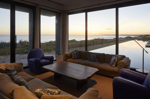 Bahía VIK José Ignacio Main Building Lower Living Room sofas cushion armchair lamp swimming pool window view interior table wood sea sand bush curtain