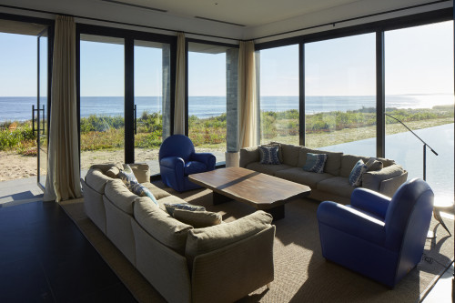 Bahía VIK José Ignacio Main Building Lower Living Room sofas cushion armchair lamp swimming pool window view interior table wood sea sand bush curtain