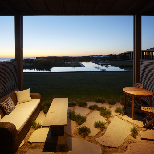 Bahía VIK José Ignacio Main Building suite view swimming pool bench sofa table grass Lounging chairs cushions sunset sunshade exterior