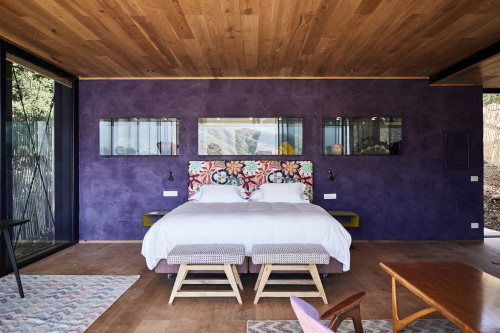 Puro VIK Chile Chihuly  window carpet bedroom double bed table armchair lamp  purple  headboard pillows night table  bench purple cabinet sculpture