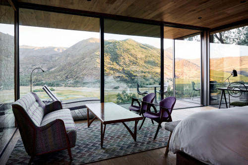 Puro VIK Chile Chihuly landscape window view mountains terrace carpet armchair bedroom double bed table desk chair  trees nature cushion lamp Lounging chairs bench sofa green purple