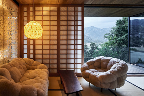 Puro VIK Chile Casas Hiroshige interior armchair sofa table terrace light lamp nature trees valley mountains