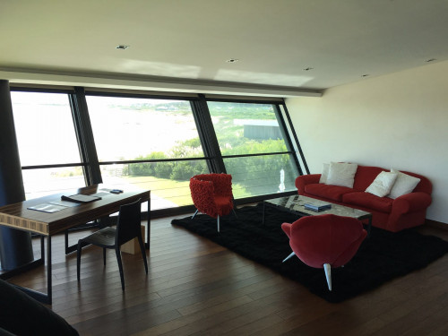 Playa VIK José Ignacio Uruguay Guest Suites interior Valentina Suite chair desk sofa cushions armchair window carpet red trees green nature books