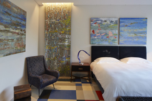 La Patricia  Guest Suite Hotel VIK  Chile interior bedroom  armchair carpet  painting lamps night table double bed headboard pillows bench