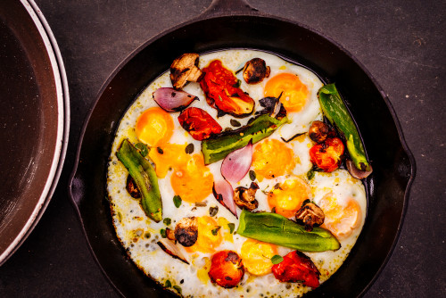 skillet vegetables eggs flower eggplant tomato food onion peppers mushrooms