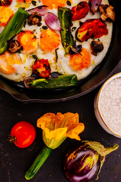 skillet vegetables eggs flower eggplant tomato food onion peppers mushrooms