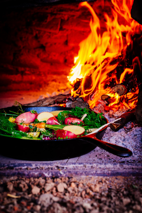 clay oven skillet flame firewood fire vegetables potato carrots beet onion rosemary food