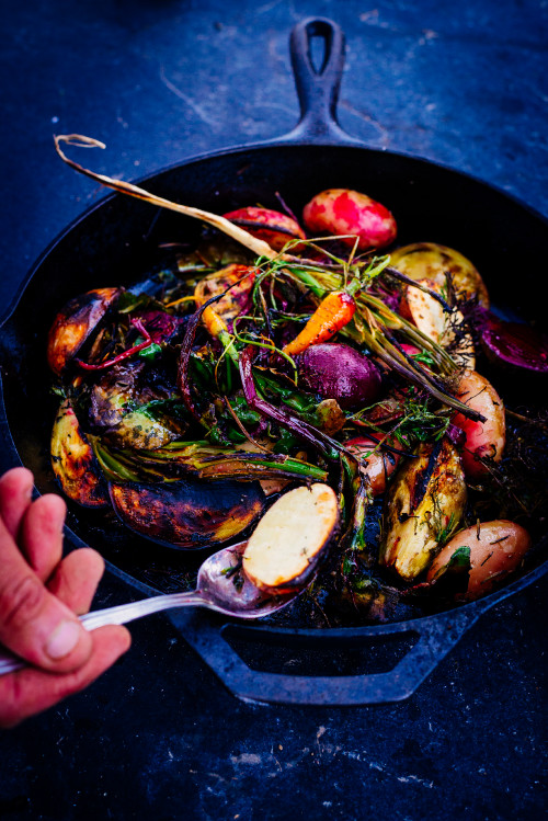 skillet vegetables potato carrots beet onion rosemary spoon food hand