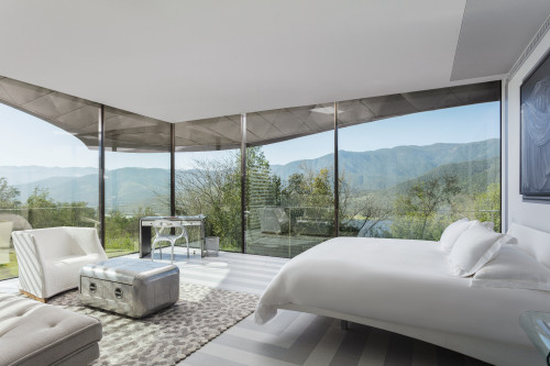 Interior VIK Hotel Rooms window view double bed table sofa lamp Gabler's Grisaille paintings landscape mountains Guest Suite Chile sofa carpet Juan Pablo Jaramillo