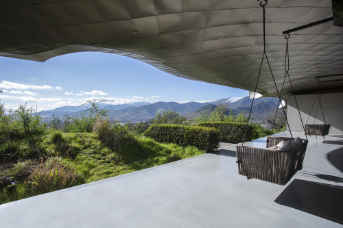 VIK Hotel sofa swing exterior cushions landscape clouds mountains green view Juan Pablo Jaramillo Chile roof