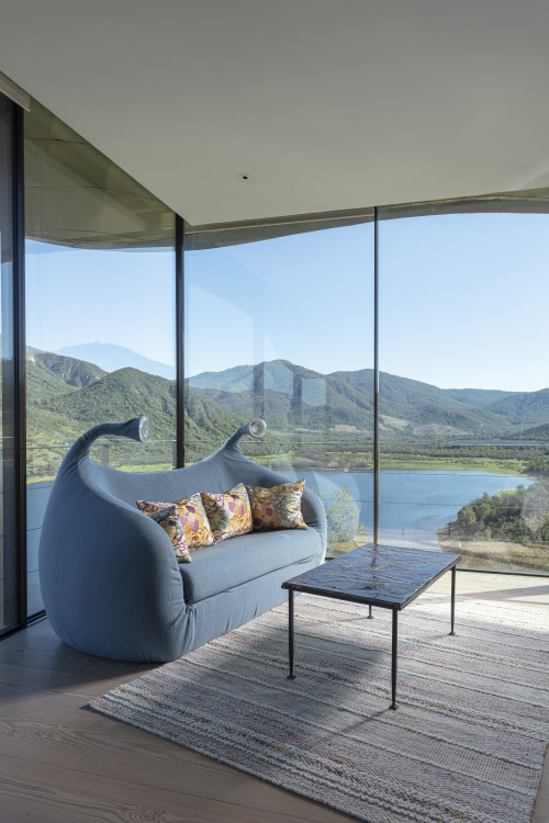 VIK Hotel Juan Pablo Jaramillo Bottle landscape window view sofa lamps valley mountains bed double cushions carpet lake reservoir table Chile