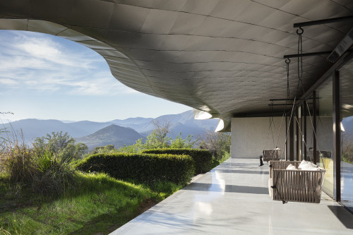 VIK Hotel sofa swing  exterior cushions window mountains green view Juan Pablo Jaramillo Chile roof