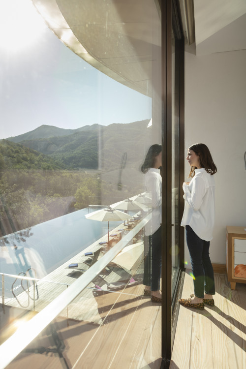 VIK Hotel Juan Pablo Jaramillo Bottle landscape window view valley mountains swimming pool lounge chair sunshade woman Chile