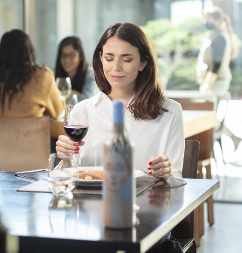 VIK Hotel dining table  window view woman  Juan Pablo Jaramillo dinner lunch plate glass bottle red wine La Piu Belle people Milla Milla Restaurant Chile