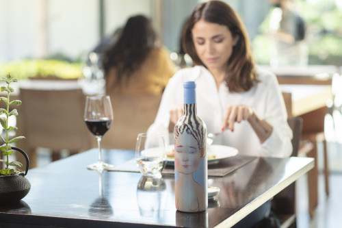 VIK Hotel dining table  window view woman  Juan Pablo Jaramillo dinner lunch plate glass bottle red wine La Piu Belle plant tattoo people Milla Milla Restaurant Chile