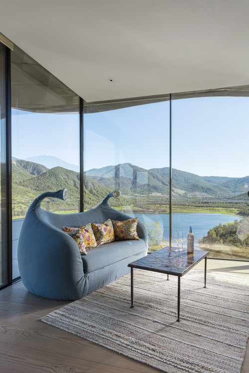 VIK Hotel Juan Pablo Jaramillo Bottle landscape window view sofa lamps glass red wine La Piu Belle valley mountains  cushions carpet lake reservoir glass Master Suite Chile